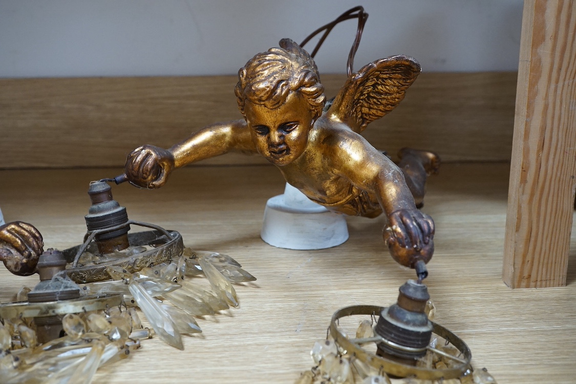 A pair of gilt twin branch cherub chandeliers with glass drops. Condition - some losses